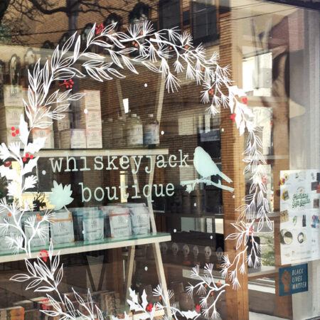 Painted storefront window at Whiskey Jack Boutique